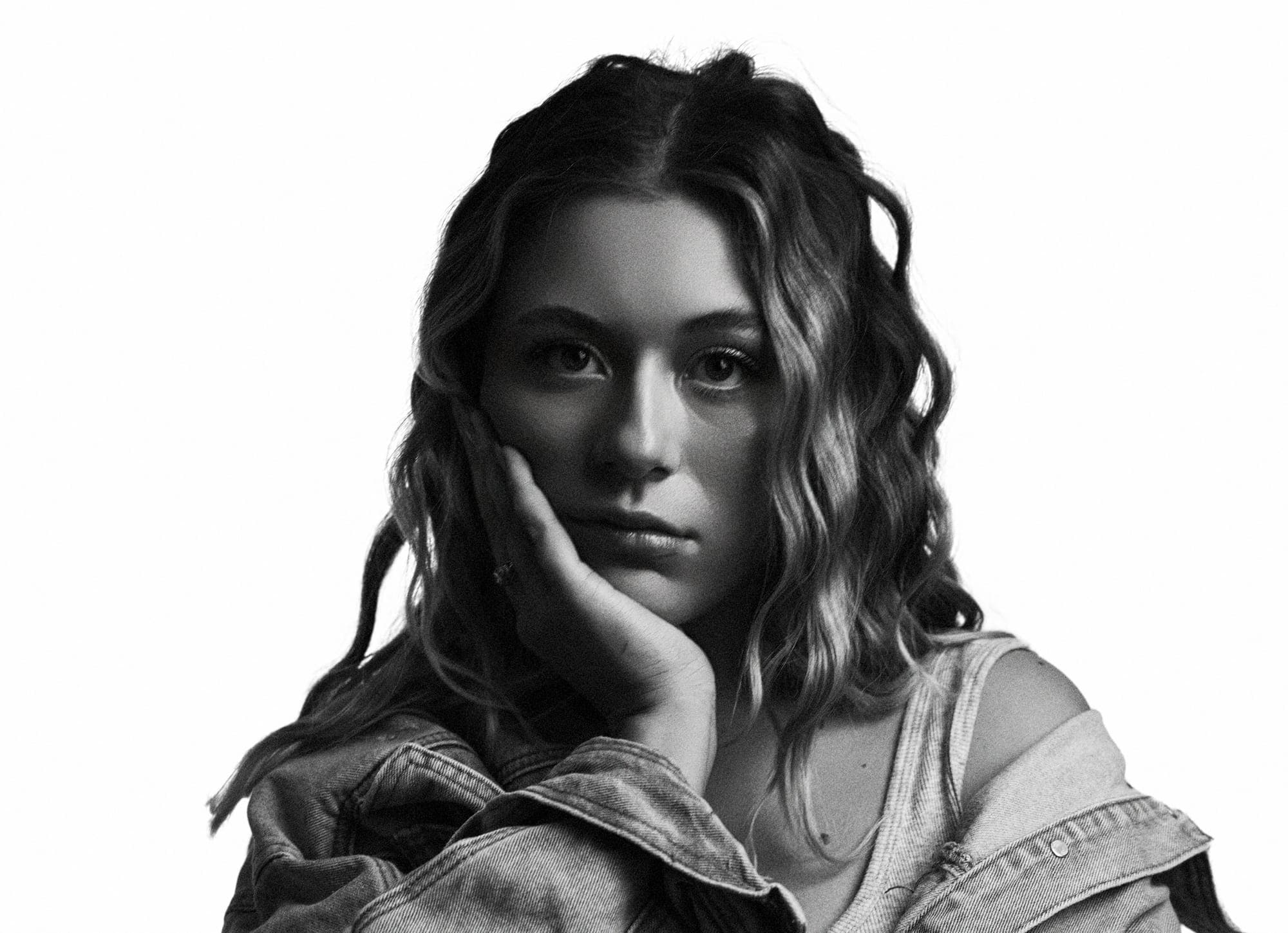 black and white portrait of hannah, chin resting on her hand